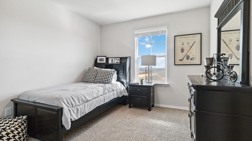 Hacienda Model Secondary bedroom with carpet, closet and window.