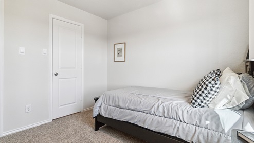 Hacienda Model Secondary bedroom with carpet, closet and window.