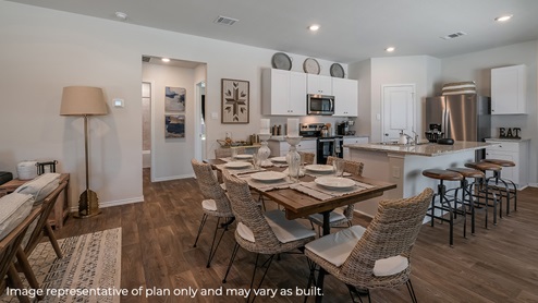 Open-concept dining area overlooking kitchen.