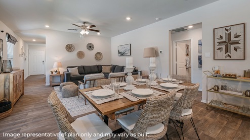 Dining area with window, sitting between living area and kitchen.