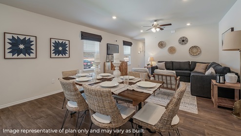 Open-concept dining area with windows and hard surface flooring.
