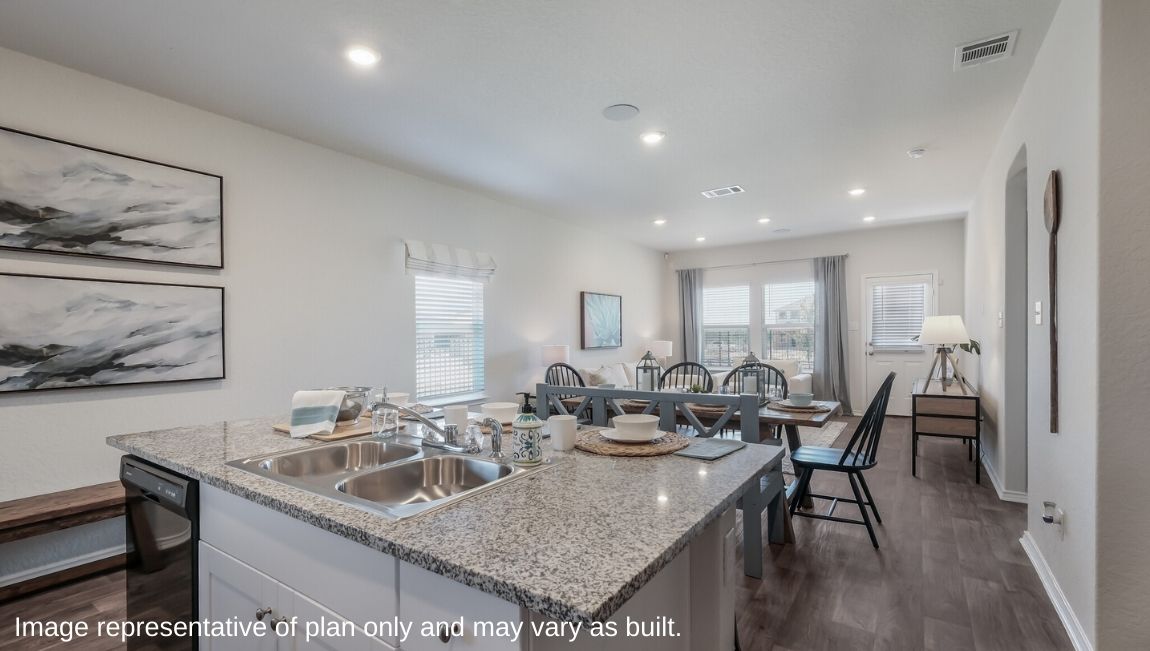 Open-concept kitchen overlooking dining area and living area.