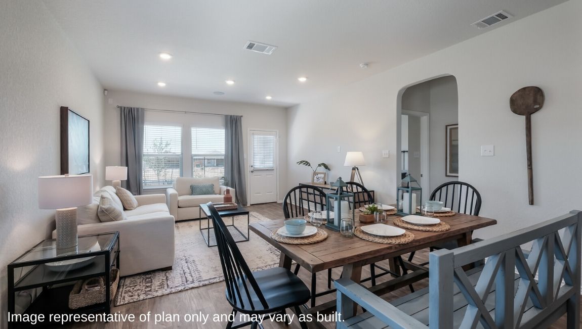 Open-concept living area with hard surface flooring and windows providing plenty of natural light.
