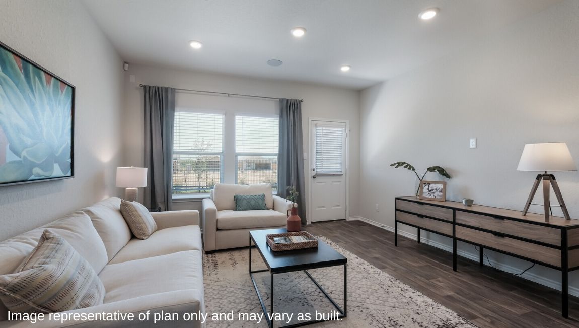 Spacious living area with large windows and patio doors.