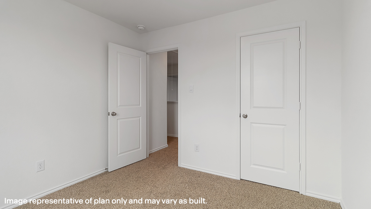 View of the bedroom overlooking the closet and hallway doors