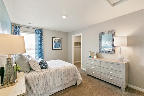 Bedroom with full size bed, dresser and decor
