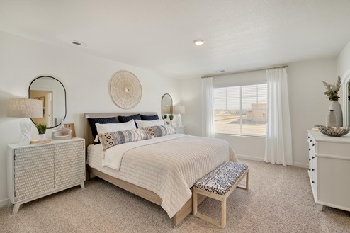 spacious bedroom with king size bed, nightstands, and sitting area