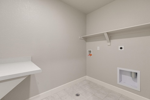 laundry room with washer and dryer hook up with shelves