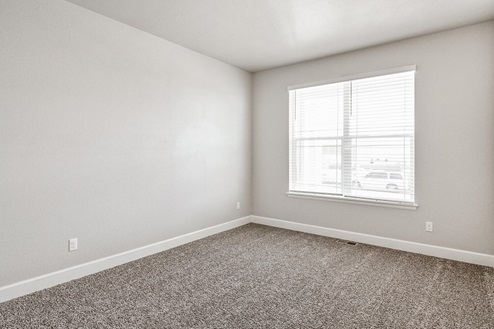 bedroom with a window and carpet floor