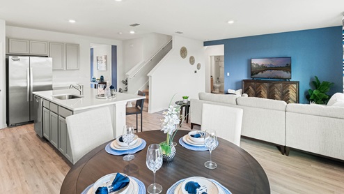 Dining space with round table overlooking the kitchen and living room
