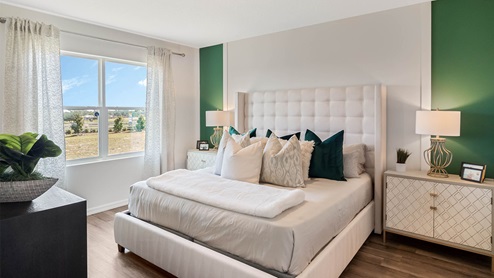 Primary bedroom with king size bed, nightstands, and dresser
