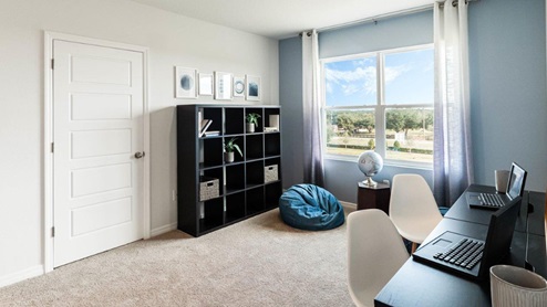 Upstairs loft space with bookshelf and desks