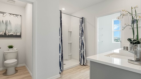 Primary bathroom with walk in shower and two walk in closets