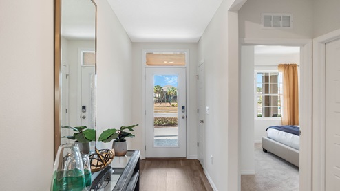 Entrance with luxury vinyl plank flooring and access to guest bedrooms