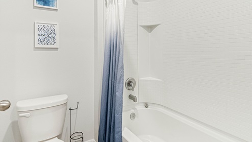 Upstairs guest bathroom with tub
