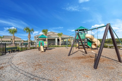 Community playground with swing set and slides
