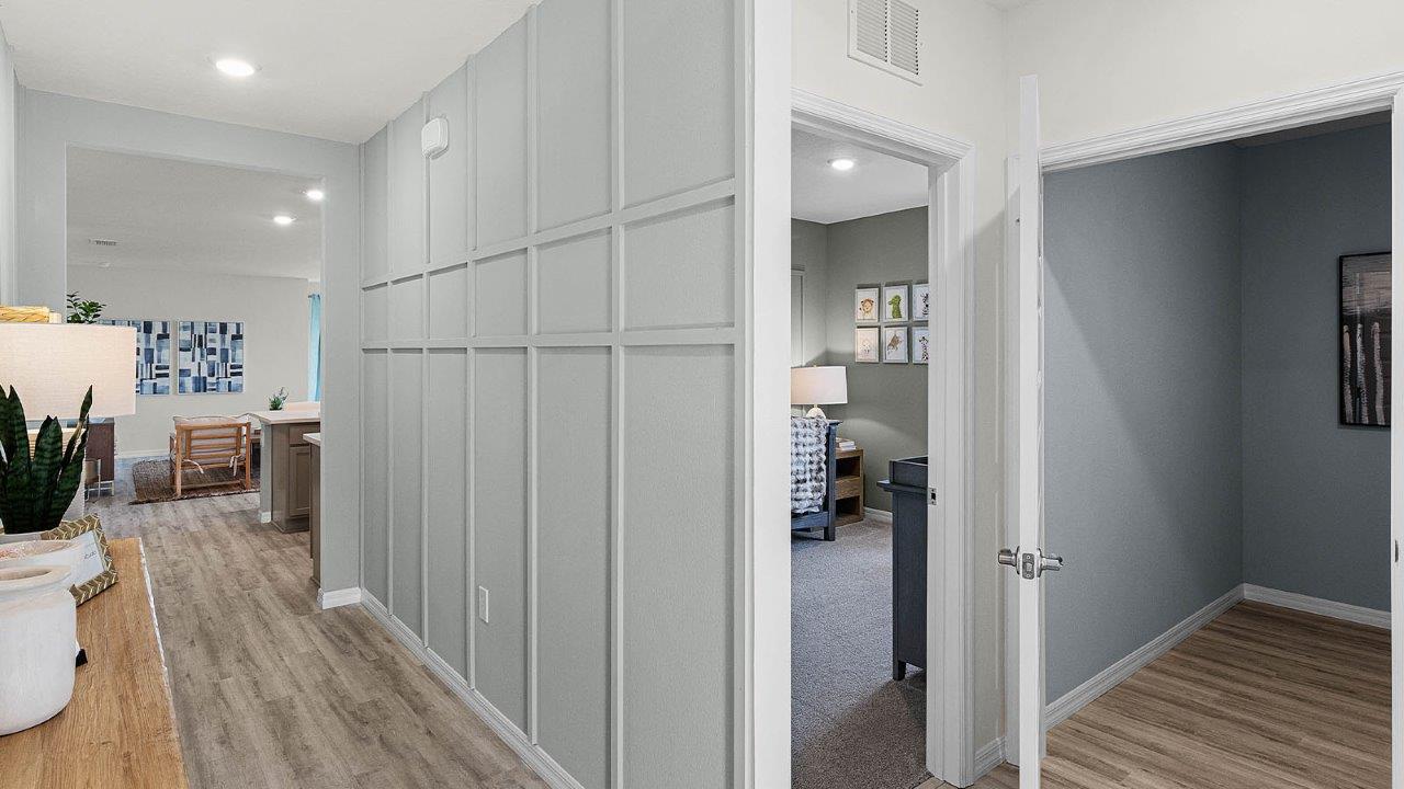 Hallway to guest bedrooms and open concept living spaces