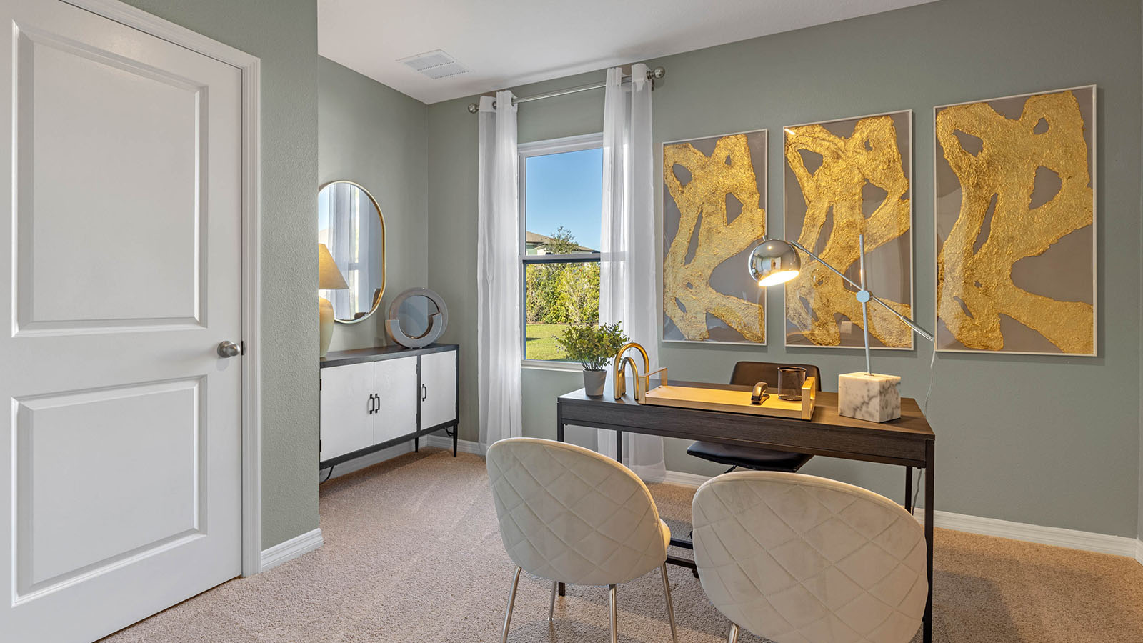 Guest bedroom staged as an office with desk and chairs
