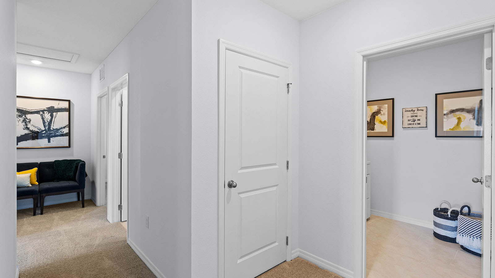 Upstairs hallway with laundry room and bench