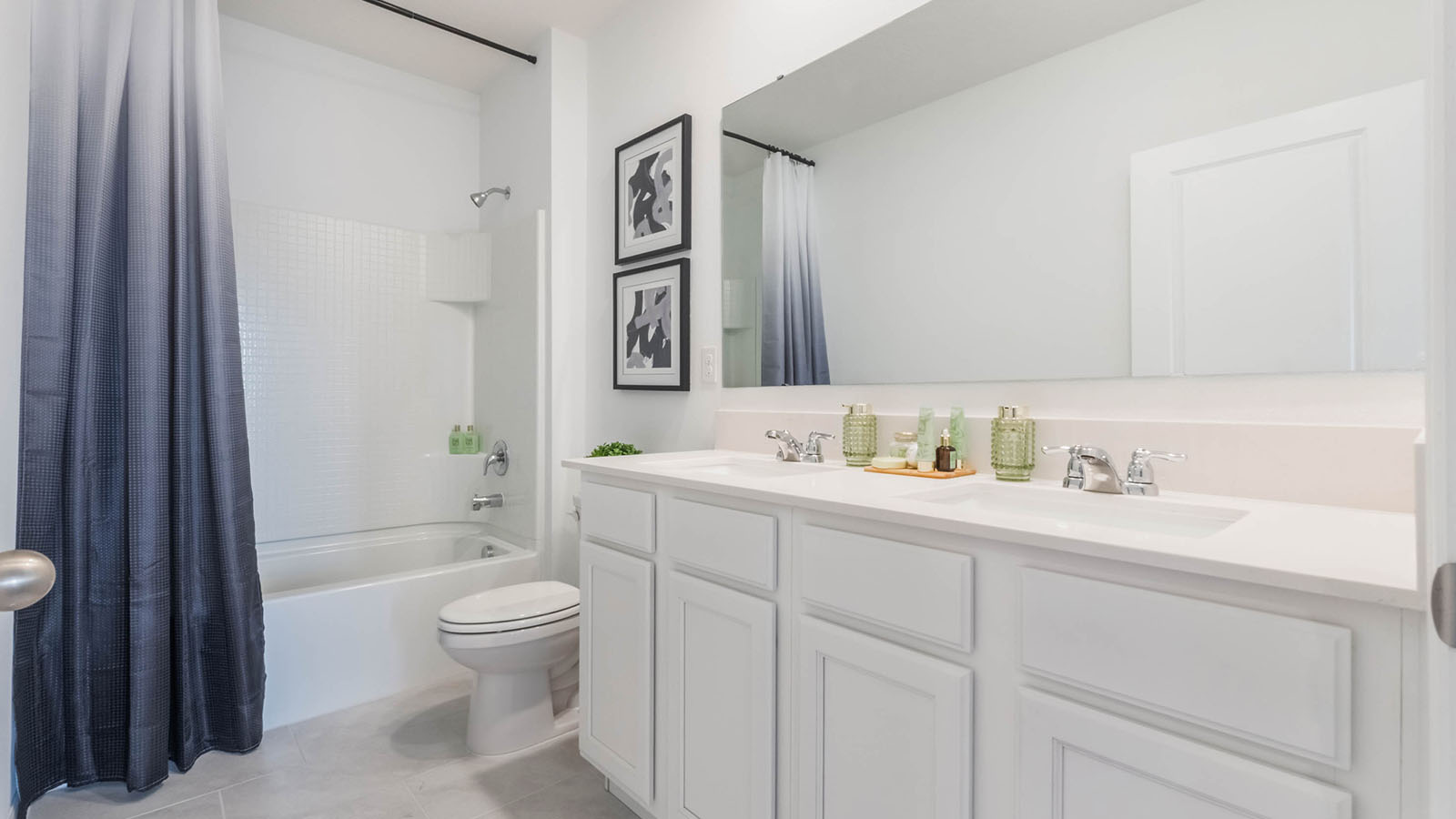 Upstairs guest bathroom with double vanity sinks and tub