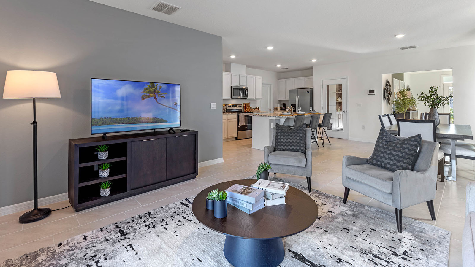 Living room with two chairs overlooking the kitchen