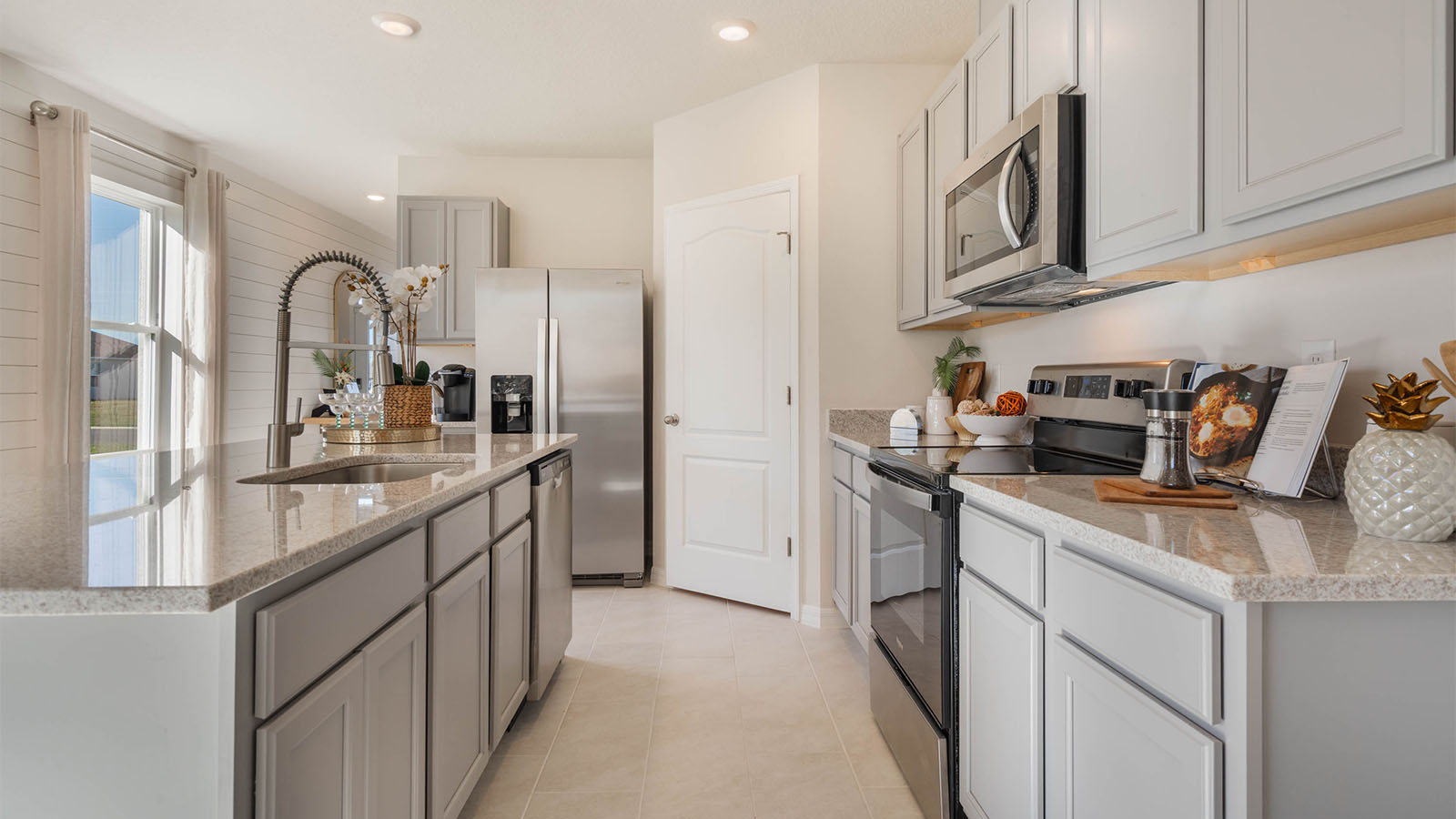Kitchen area with white cabinets and quartz countertop