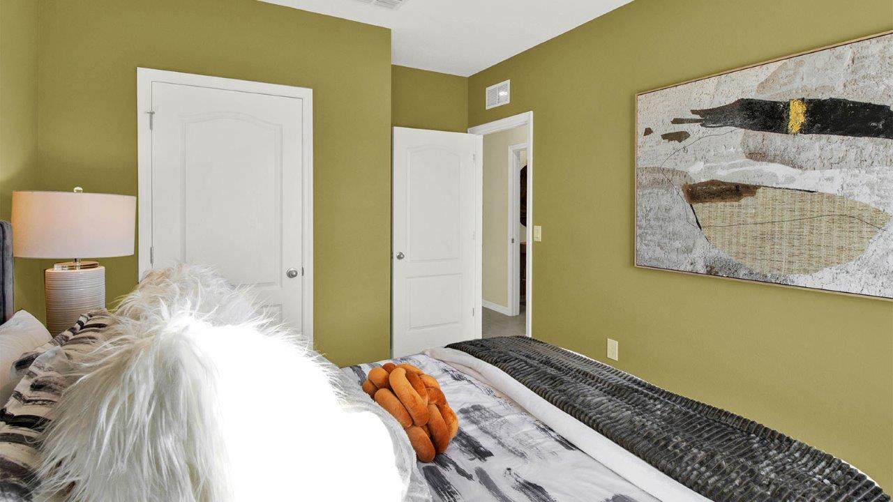 Guest bedroom with queen size bed and closet