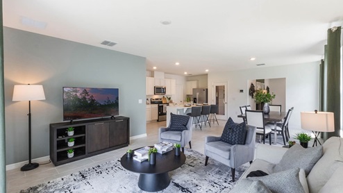 Open concept living spaces of dining room, kitchen and living room