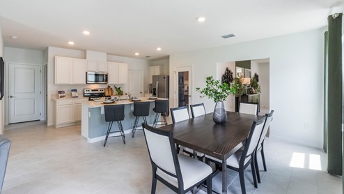 Open concept living spaces of dining room and kitchen