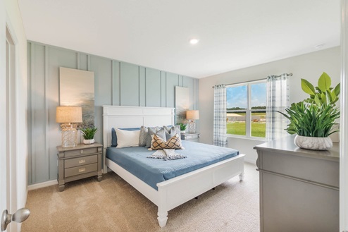 Large primary bedroom wiht king size bed, walk in closet, and attached bathroom