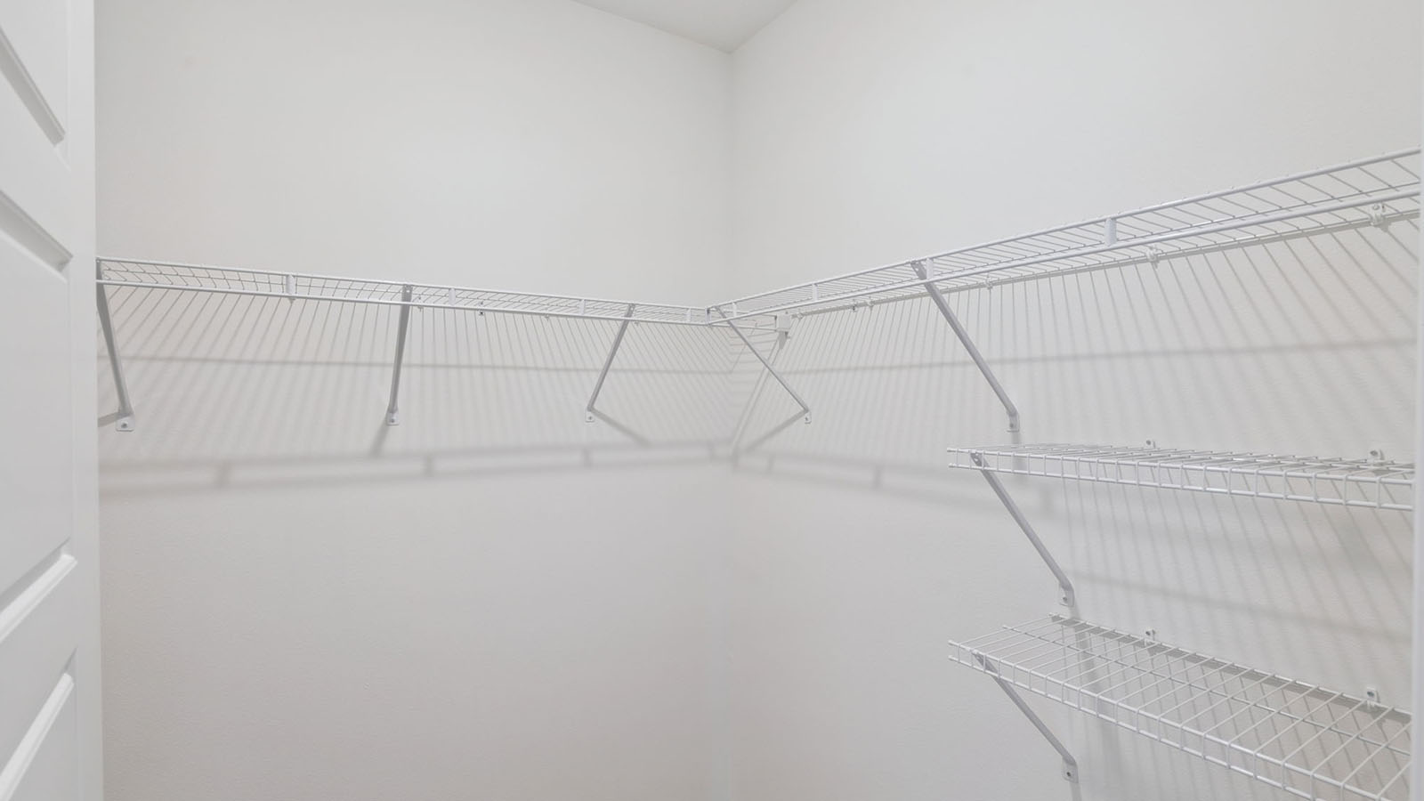 Walk in closet of primary bedroom