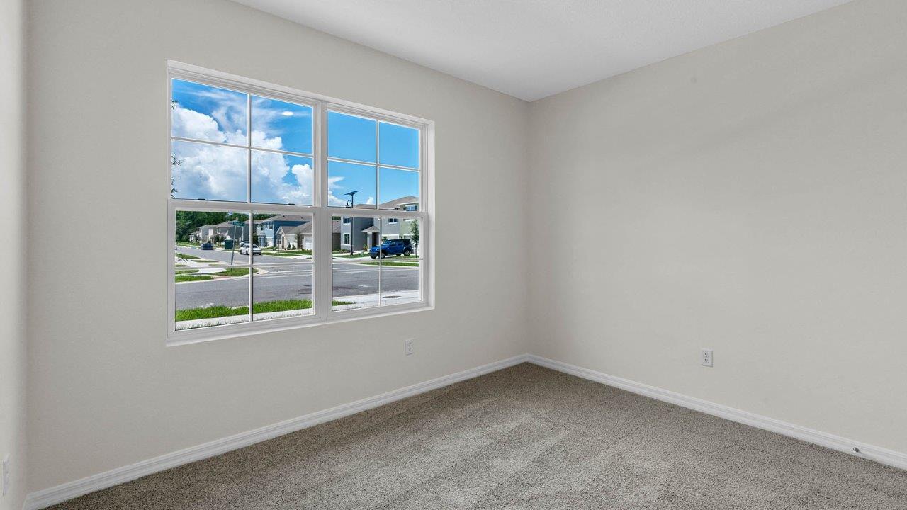 Guest bedroom with large window and natural light
