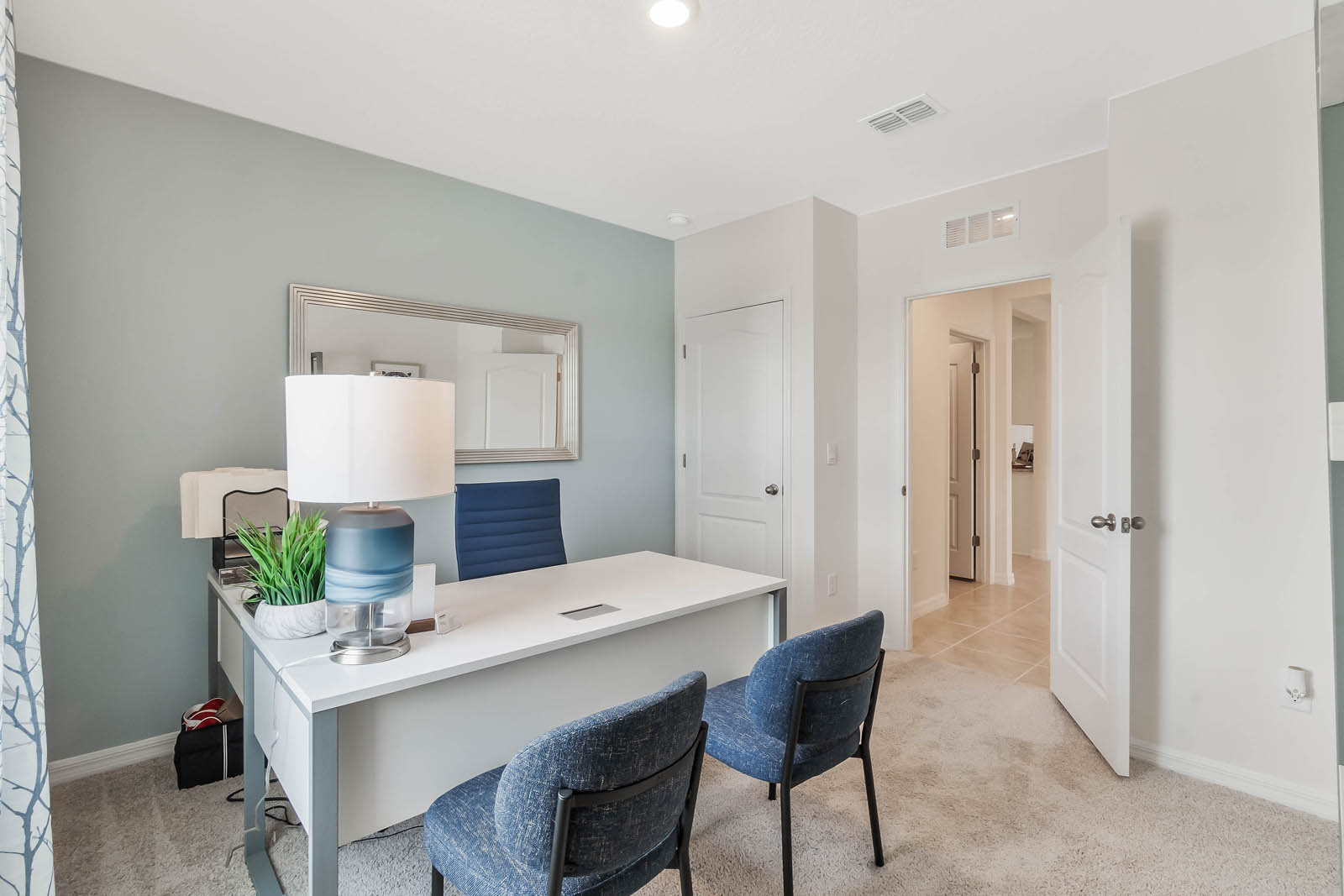 Home office space with desk and chairs