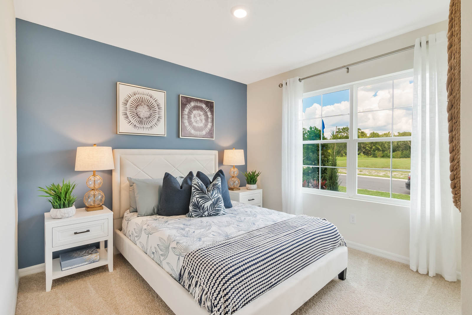Guest bedroom with queen size bed and large windows