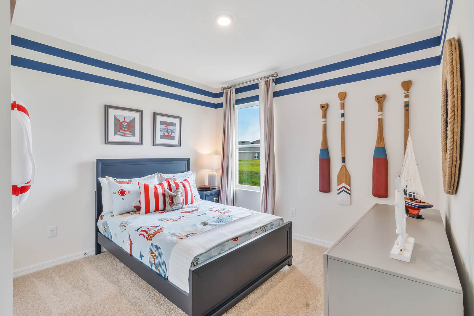 Guest bedroom with nautical theme and natural light