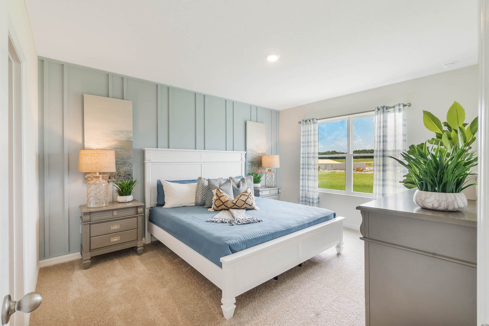 Primary bedroom with king size bed and large windows