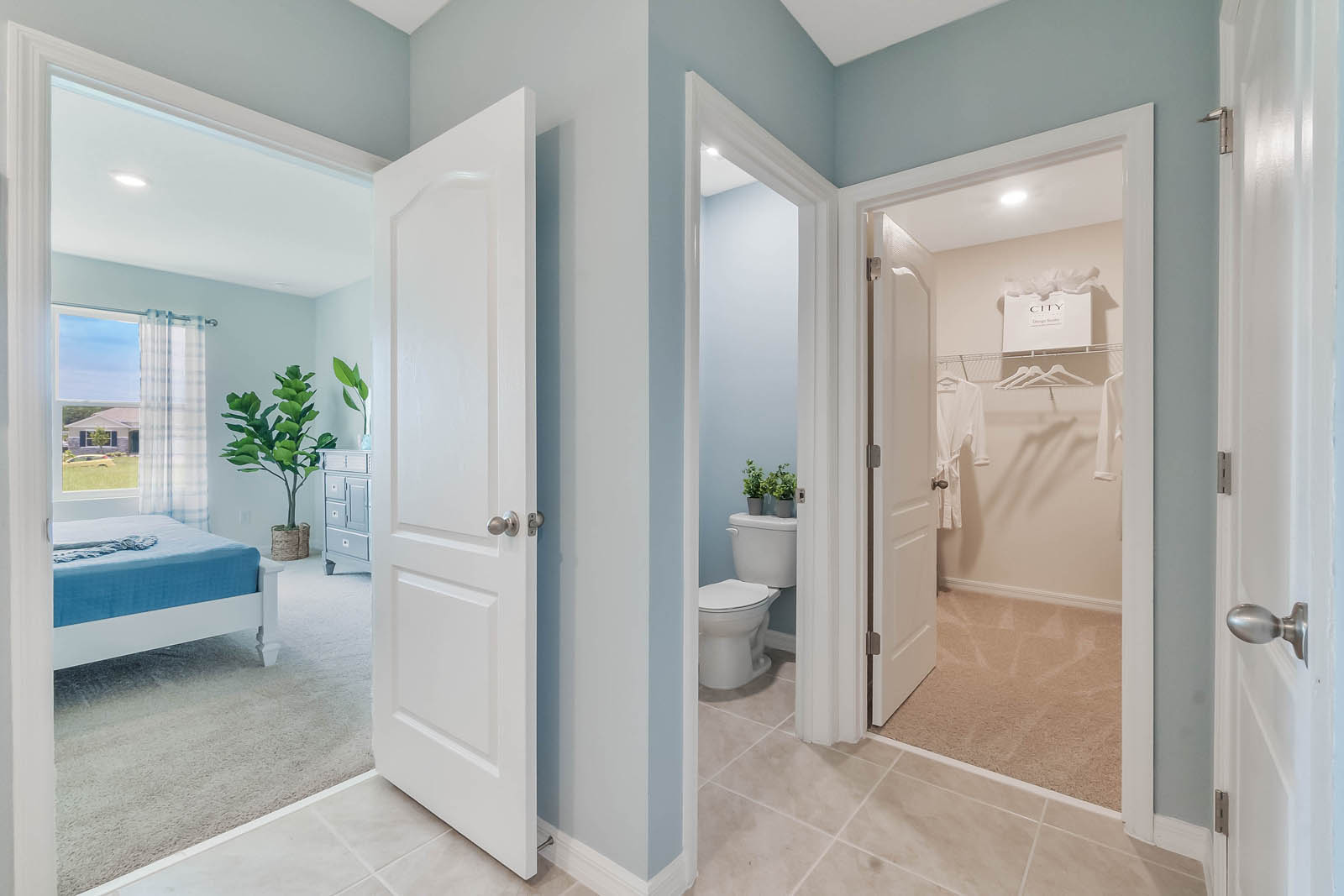 Primary bathroom with linen closet and walk in closet