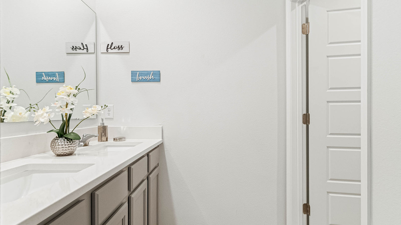 second-floor bathroom with double vanity sinks between two bedrooms
