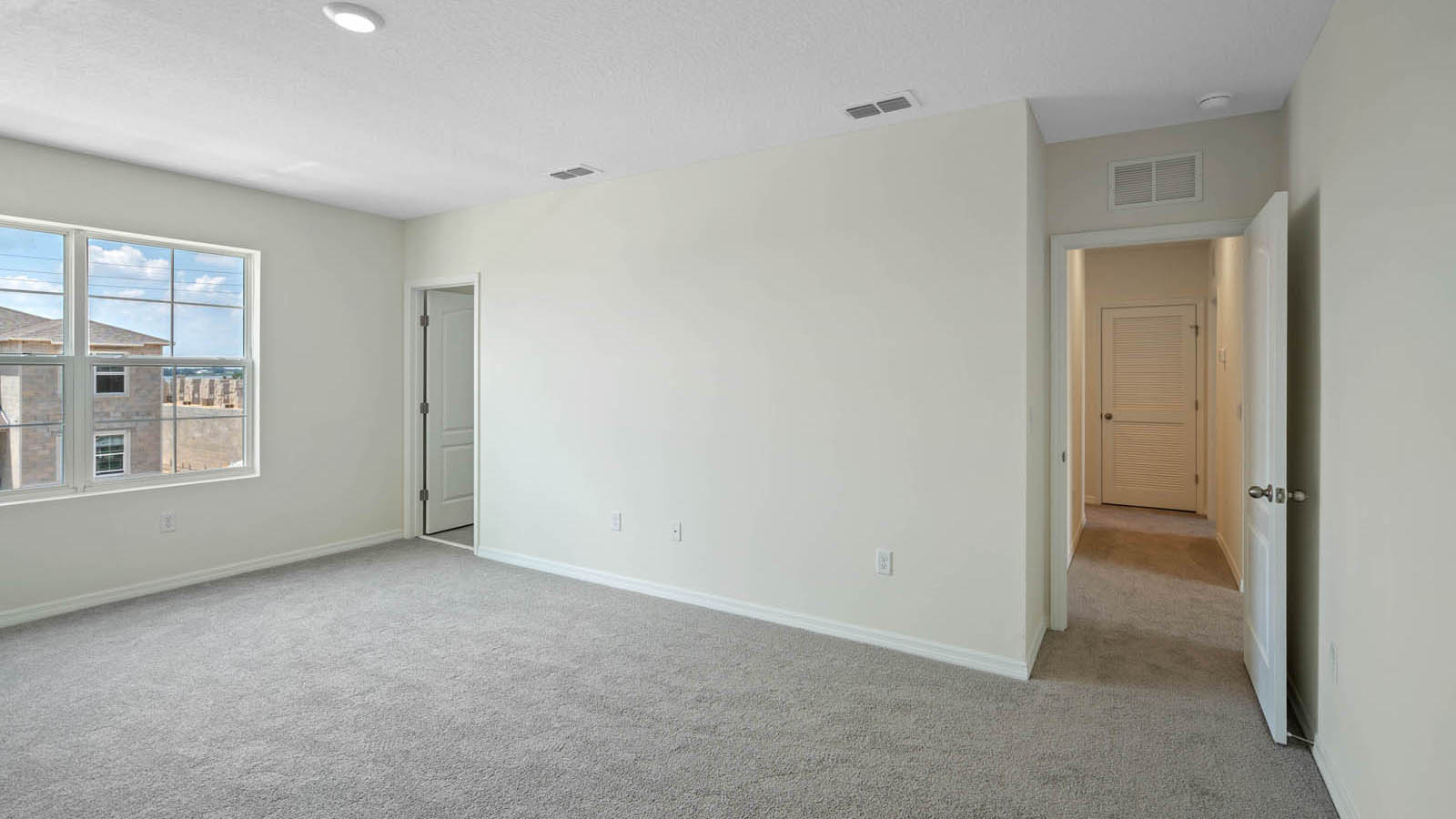 Primary bedroom with walk in closet and attached bathroom