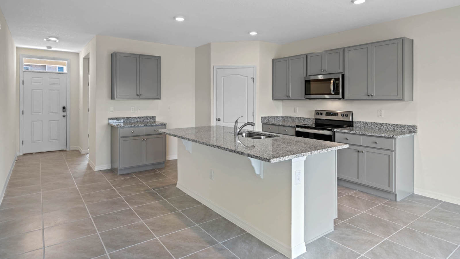 Open concept kitchen with large island and gray cabinets