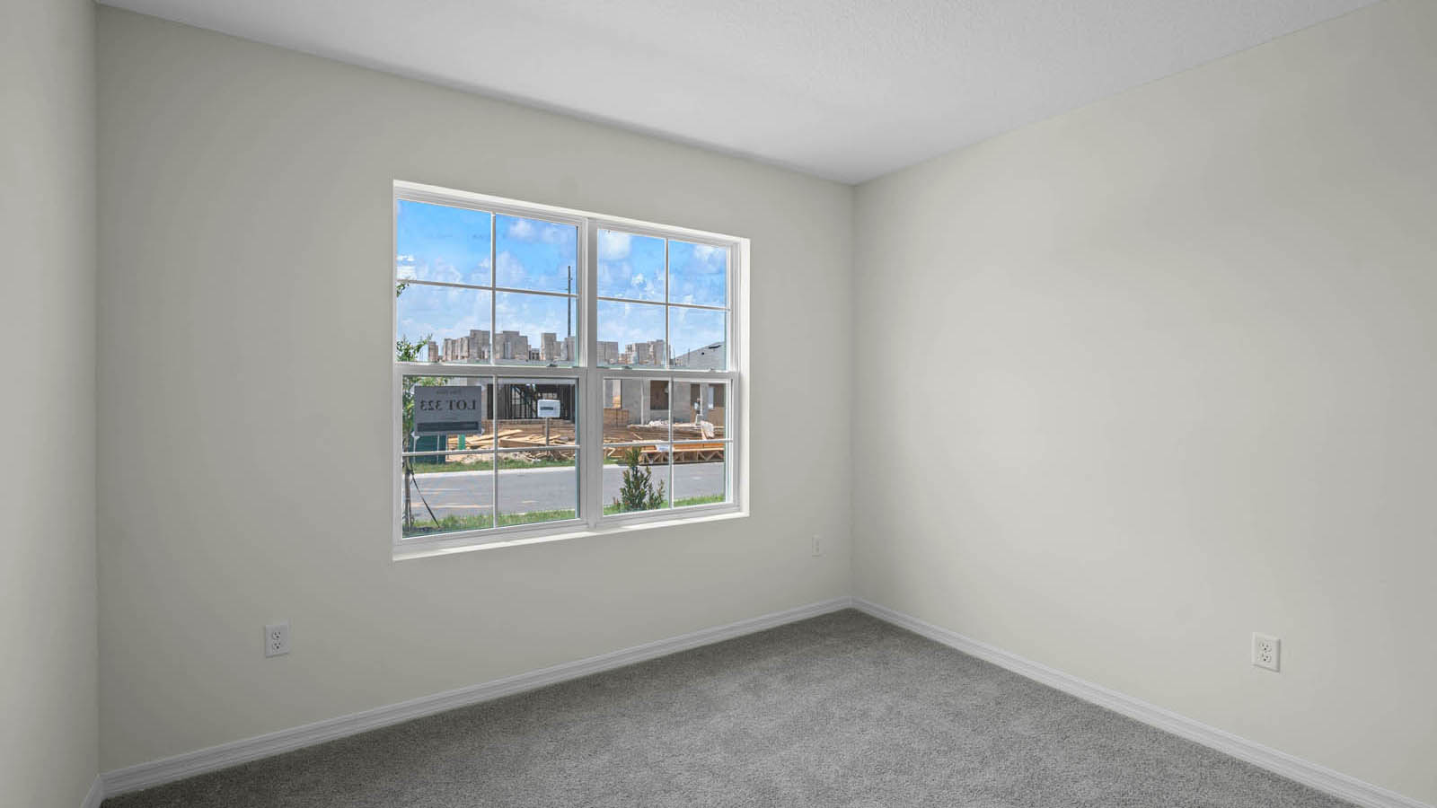 Second-floor guest bedroom with two windows and carpet