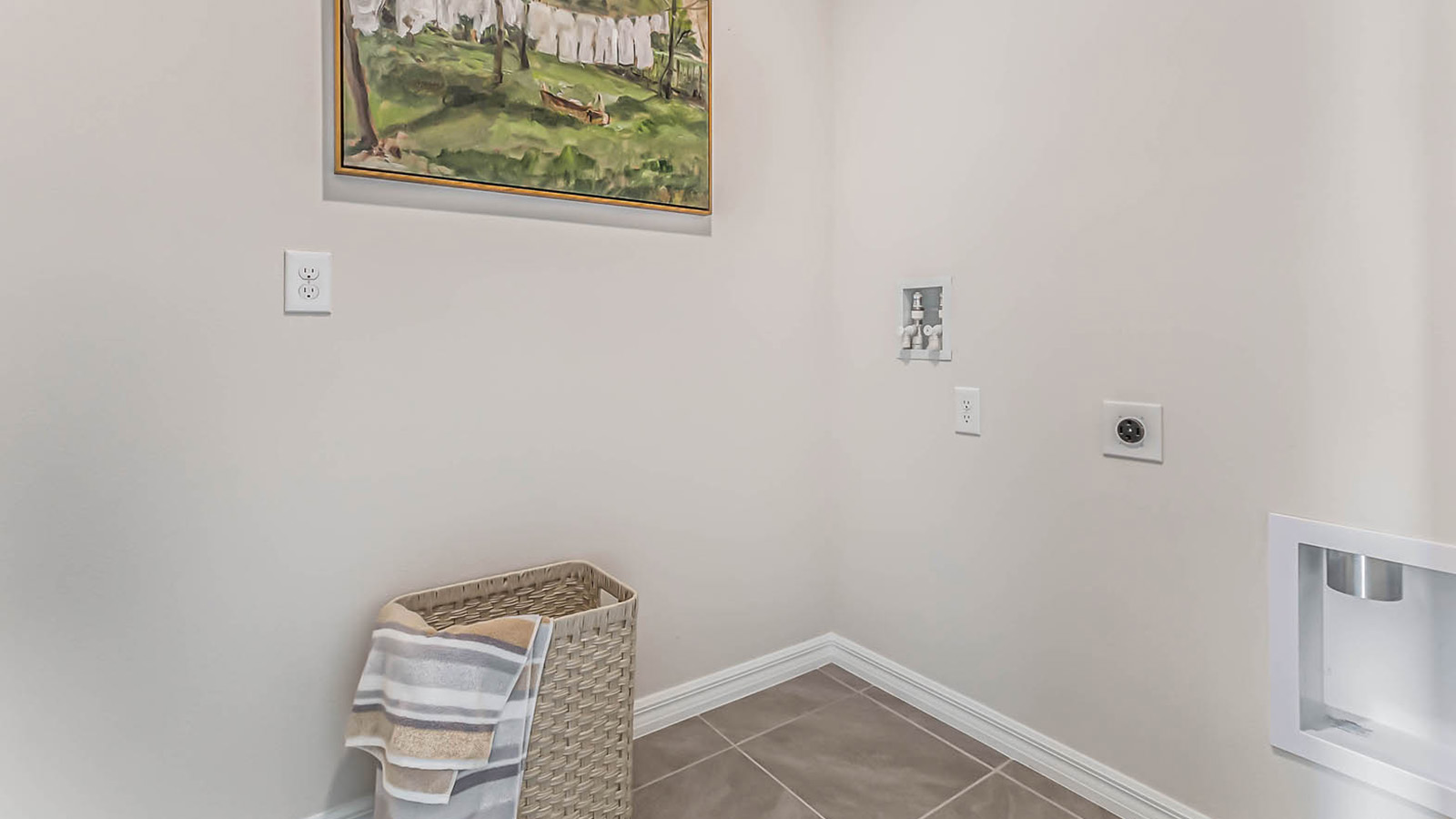 Laundry room with basket and art