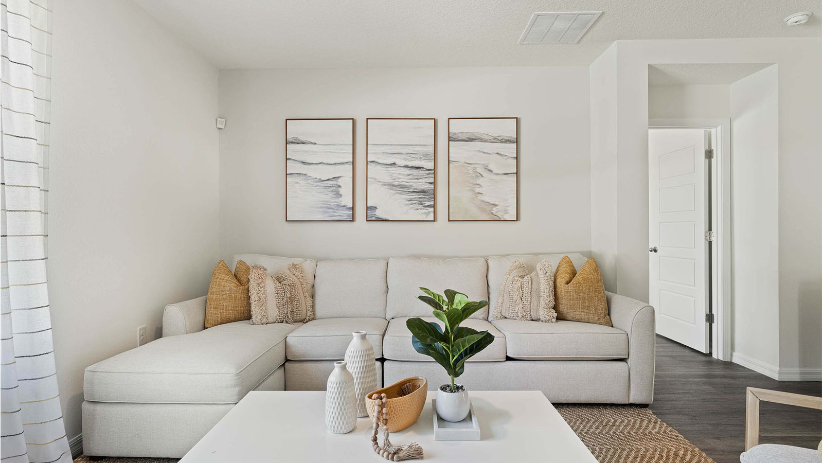 Living room with sectional and luxury vinyl plank floors