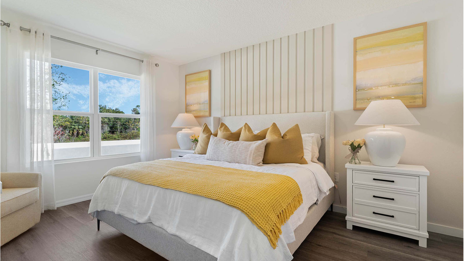 Primary bedroom with luxury vinyl plank floors and two-windows