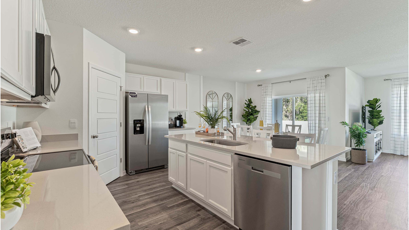 Kitchen island with built in sink overlooking the dining room