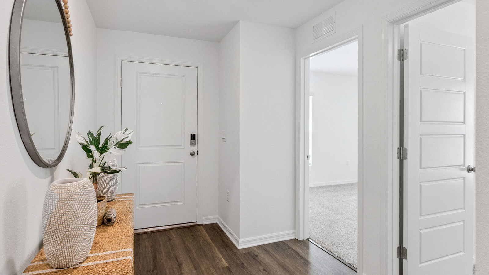 Entry way with table and view of one guest room