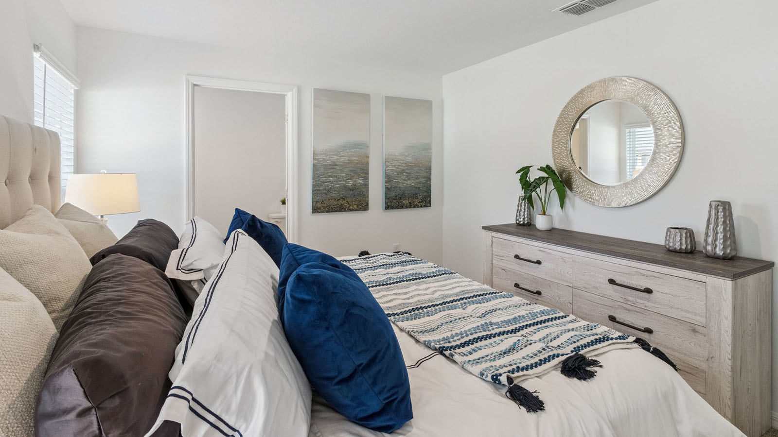 Primary bedroom with bed and dresser