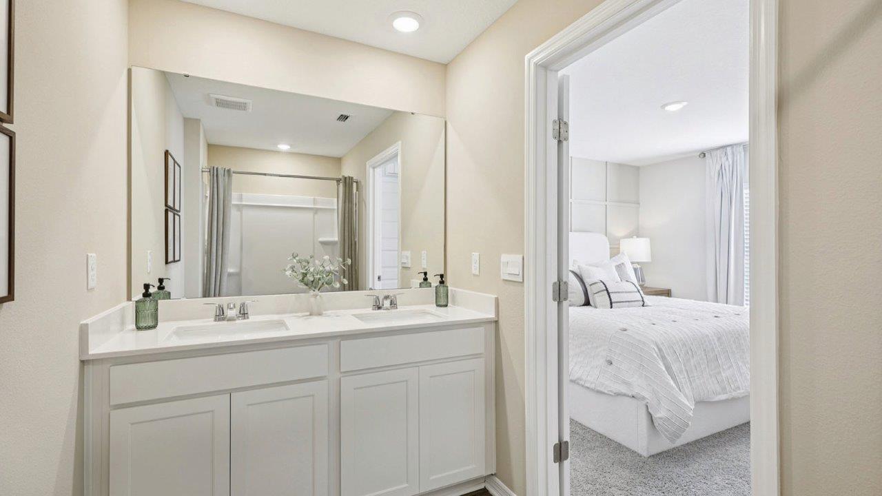 Primary bedroom ensuite bathroom with dual vanity sinks