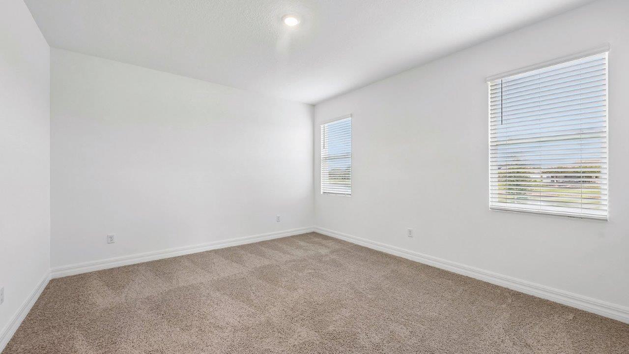 Spacious primary bedroom with carpet