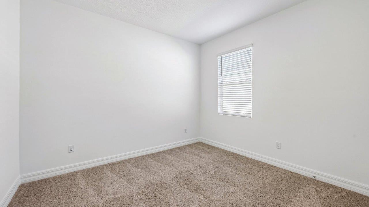 Guest bedroom with carpet and built in closet